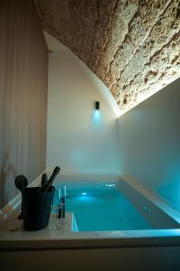a bath tub with a blue light in a bathroom at Myra Bari Bed & Spa in Bari