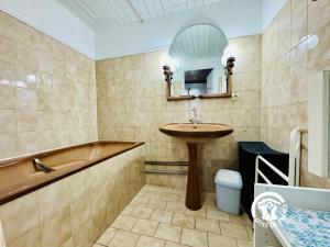 a bathroom with a sink and a tub and a toilet at Oustal marcellin in Fanjeaux +20 photos