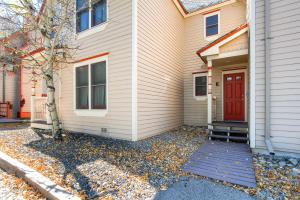 a house with a red door on the side of it at Victorian Gables E by Ski Country Resorts in Breckenridge