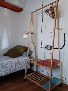 a wooden ladder shelf in a bedroom with a bed at Ca La Martona in Rubio de Dalt