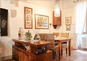 a dining room with a wooden table and chairs at La casa degli esposti in Anghiari