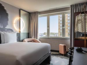 a hotel room with a bed and a window at Tribe Amsterdam City in Amsterdam +68 photos