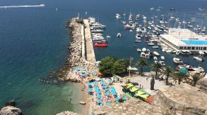 an aerial view of a crowded beach with boats at Woodpecker Hostel Montenegro in Zelenika