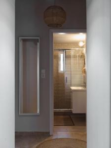 a bathroom with a shower and a sink and a mirror at Theros in Karistos