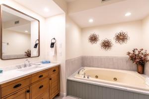 a bathroom with a tub and a sink and a mirror at Chetola: Chestnut 8 in Blowing Rock +37 photos