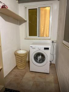 a washing machine in a small room with a window at Spacious Peaceful Apartment - Tarxien in Tarxien