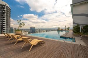 a swimming pool on the roof of a building at The Retrograde at The Crestmont in Manila