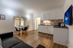 a kitchen and living room with a couch and a table at paleocapa 6 bilocale in Savona