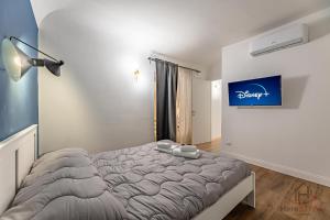 a bedroom with a bed and a blue sign on the wall at paleocapa 6 bilocale in Savona