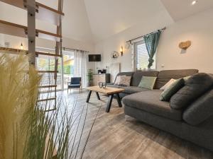 a living room with a couch and a table at Hasn Res in Kleinwinklarn