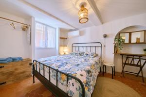 a bedroom with a bed and a table in it at Romantic getaway in Bormes in Bormes-les-Mimosas
