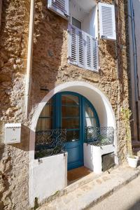 a blue door on the side of a building at Romantic getaway in Bormes in Bormes-les-Mimosas