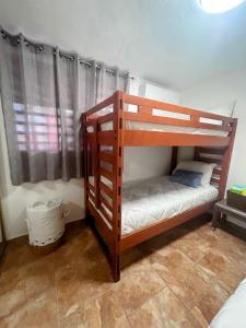 a bunk bed in a room with a window at Daisy'Hause 2 to 6 people, ideal for your family in Carolina