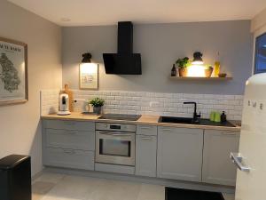 a kitchen with a sink and a stove at NUIT ET JOUR à Chaumont in Chaumont