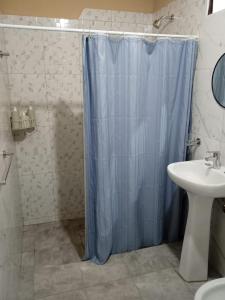 a bathroom with a shower curtain and a sink at Parador Diaguita in El Peñón +15 photos