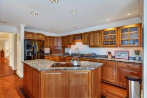 a kitchen with wooden cabinets and a sink at Edson Hill Estate in Stowe