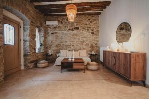 a bedroom with a bed in a stone wall at Theros in Karistos