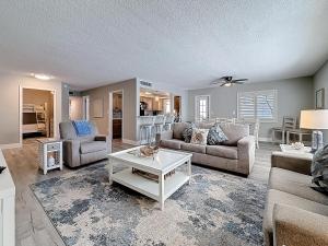 a living room with two couches and a table at Waves 9 in St Pete Beach