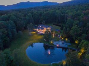 an aerial view of a house with a pond at Edson Hill Estate in Stowe Fork
