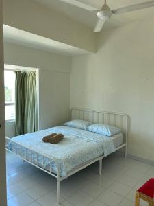 a bedroom with a bed with a hat on it at Budget Friendly 3Bedroom Walkable to USM in Gelugor +28 photos