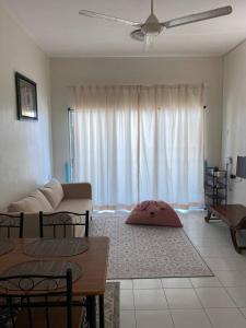 a living room with a couch and a table at Budget Friendly 3Bedroom Walkable to USM in Gelugor