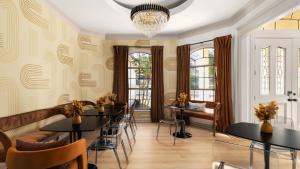 a dining room with tables and chairs and a chandelier at Expansive Lakehouse W Stunning Pool & Views in The Hills