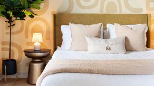 a bedroom with a bed with white sheets and pillows at Expansive Lakehouse W Stunning Pool & Views in The Hills +63 photos
