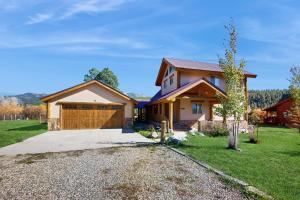 a house with a driveway and a garage at Riverfront Lodge in Pagosa Springs