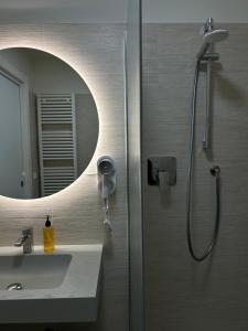a bathroom with a shower and a sink and a mirror at La Casa Del Viaggiatore in Grassobbio +9 photos