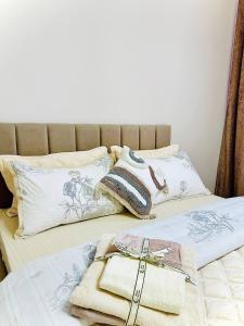 a bed with two pillows and a purse on it at K7 Family in Atyraū