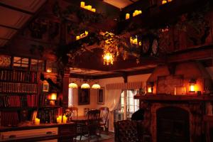 a living room with a fireplace and a table with candles at Le Manoir aux Secrets in Rawdon