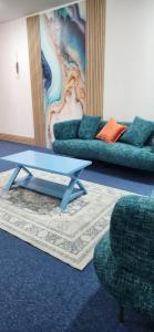 Una sala de estar con un sofá, una mesa y sillas. en Sky chalet, en Sur