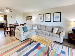 a living room with a couch and a table at Lighthouse Point by Tybee Vacation Rentals in Tybee Island