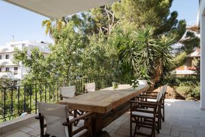 a wooden table and chairs on a patio at Voula Riviera Apartment in Athens