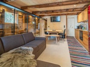 a living room with a couch and a table at Raneburg 4 Stallhaus in Matrei in Osttirol