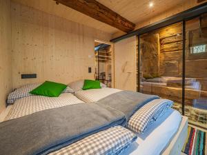 a bedroom with a large bed with green pillows at Raneburg 4 Stallhaus in Matrei in Osttirol