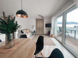 a dining room with a table and a view of the ocean at Chalet Dolní Morava in Dolní Morava