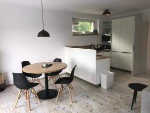 a kitchen with a table and chairs in a room at Chalet Dolní Morava in Dolní Morava