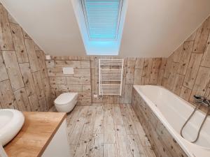 a bathroom with a white tub and a toilet at Chalet Dolní Morava in Dolní Morava +17 photos