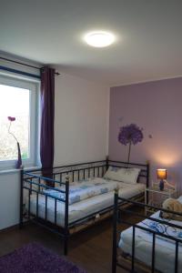 a bedroom with two bunk beds and a window at Inselblume 22 - Ferienhaus mit Garten und Hund in Landkirchen in Landkirchen