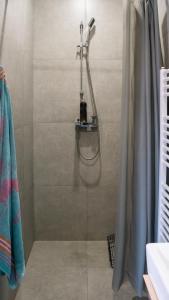 a shower with a glass door in a bathroom at Star house Sereď in Seredʼ