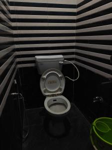 a bathroom with a white toilet in a room at Krishna guest House luxury stay in Ayodhya - 600 meter away from ram mandir in Ayodhya +11 photos