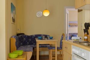 a living room with a couch and a table at Inselblume 38 - Zentrale Ferienwohnung in Burg mit Garten in Burg auf Fehmarn +9 photos