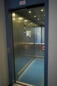 a swimming pool in a building with a glass wall at Inselblume 01 - Ferienwohnung mit Meerblick und Balkon am Südstrand in Burgtiefe auf Fehmarn 