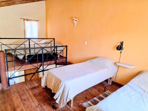 a room with two beds in a room at Cabañas Altos de Nopal in Ciudad Lujan de Cuyo +37 photos
