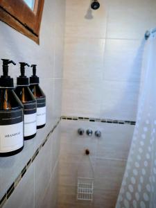 two bottles of wine sitting on a counter in a bathroom at Cabañas Altos de Nopal in Ciudad Lujan de Cuyo +35 photos
