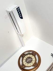 a clock hanging from the ceiling of a room at Sana Homes in Kampala