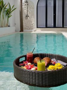 a tray of food sitting in a swimming pool at VILLA DAHO Mediterranean Elegance in Ungasan