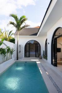 a swimming pool in the backyard of a house at VILLA DAHO Mediterranean Elegance in Ungasan
