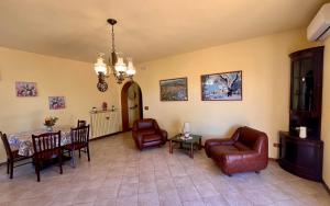 a living room with a table and chairs at Novella Dimora, nel cuore verde di Costano in Costano